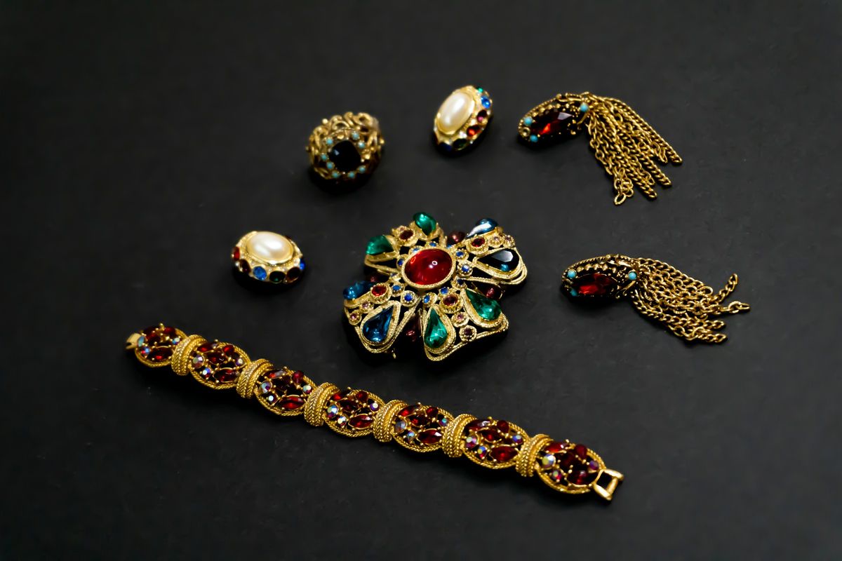 Vintage brooches, earrings and a gold bracelet set with coloured stones